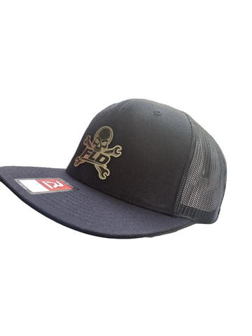 Black and navy trucker cap with mesh back and logo on a white background