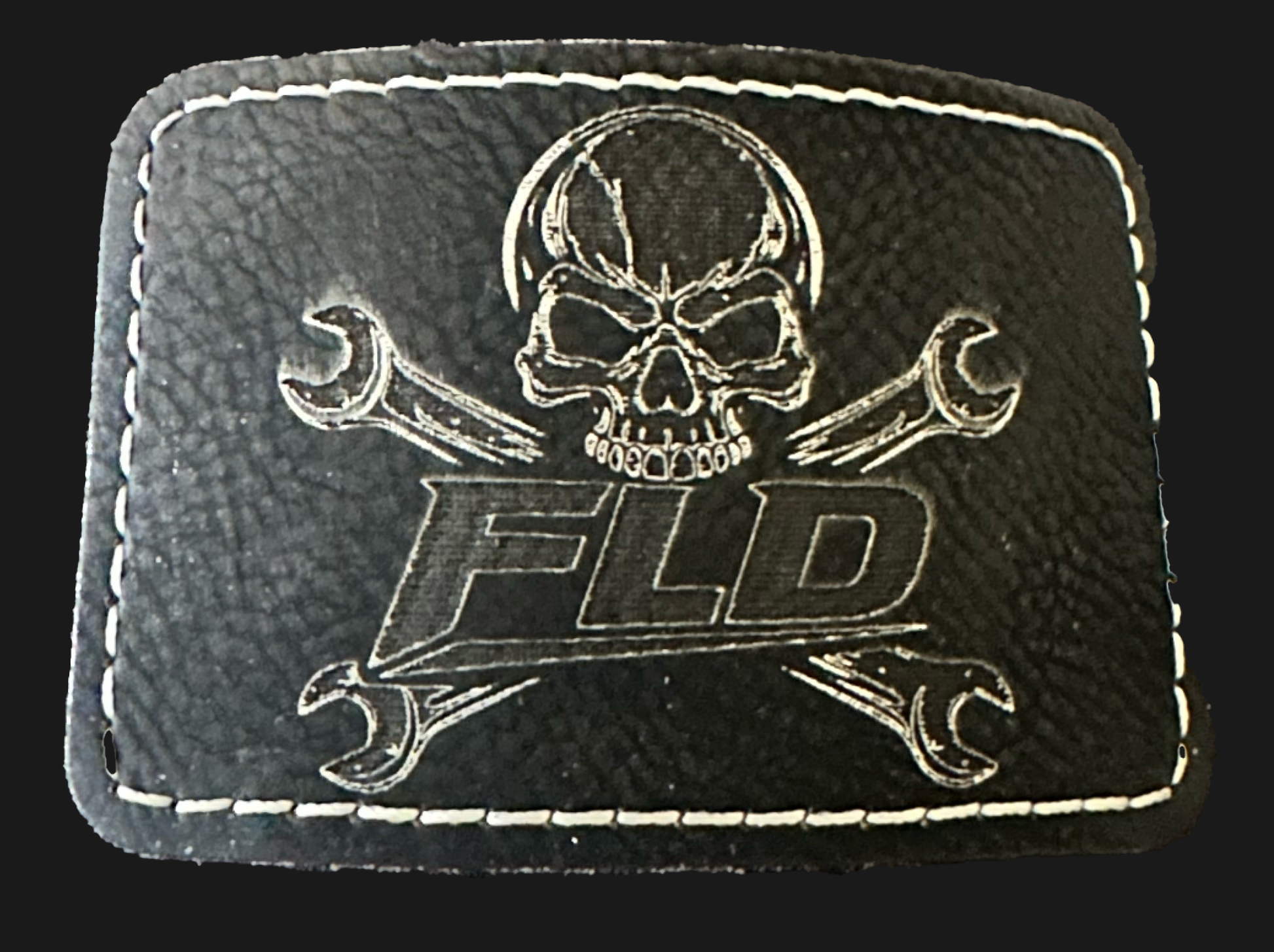 Black leather patch with skull and wrenches design and 'FLD' branding on a black background