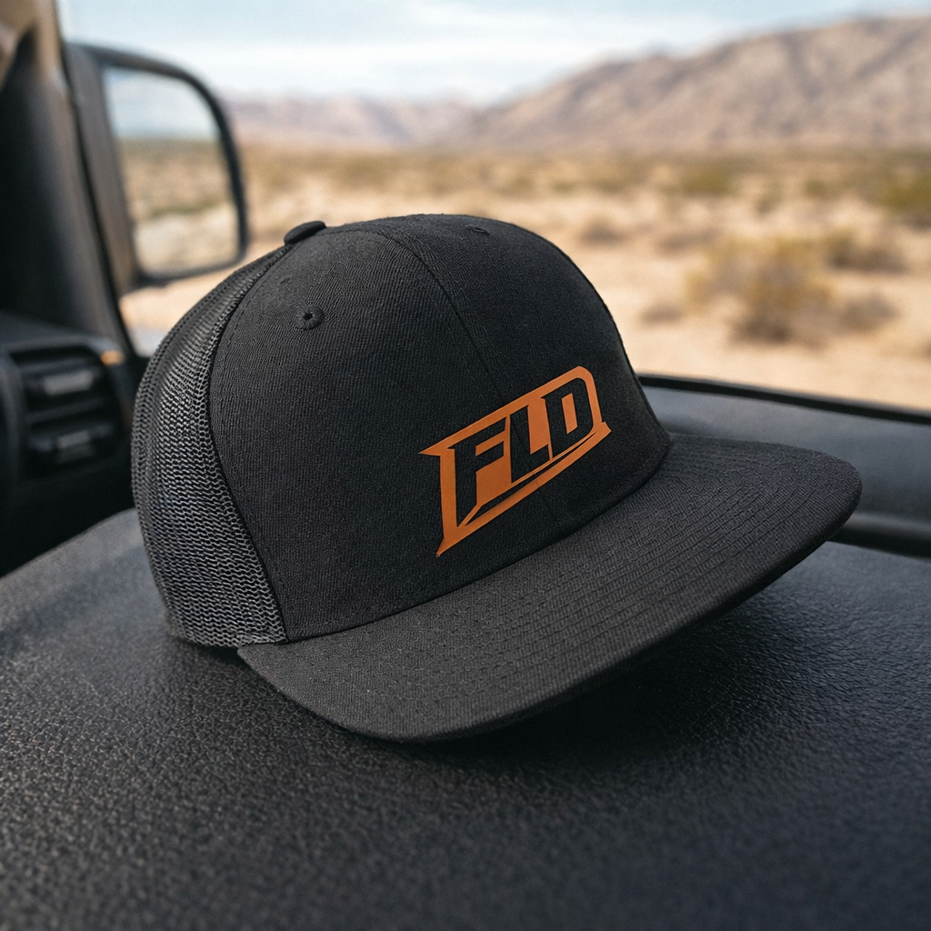 Black and gray cap with rawhide logo on a white background