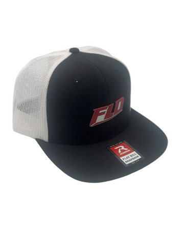 A black and white trucker hat with a black front panel and brim, white mesh back, and a red embroidered 'FLO' logo on the front. A red and white size sticker is attached to the brim.