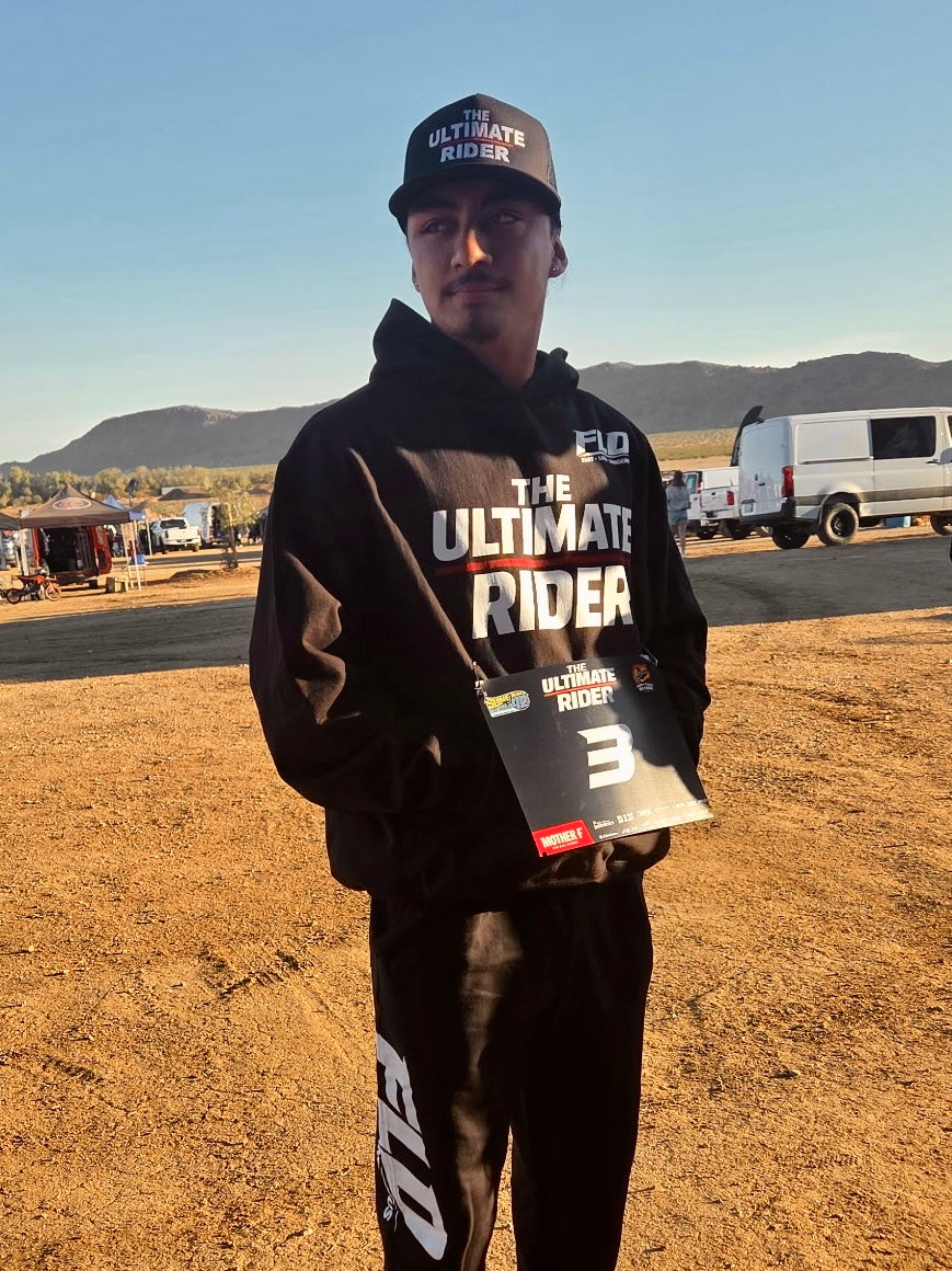 Ultimate Rider contestant wearing FLD “The Ultimate Rider” hoodie at event in desert setting